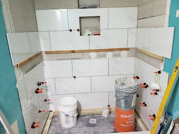 Bathroom shower tile installation in progress